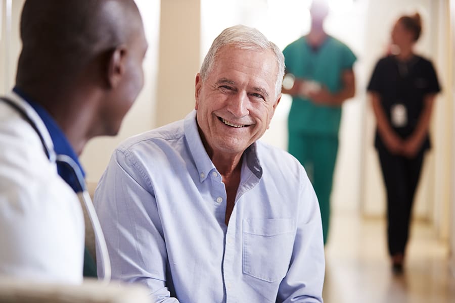 Two men talking and smiling