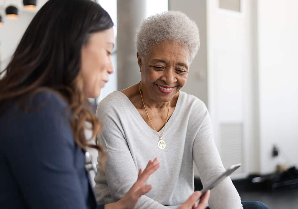 Two Ladies smiling and looking at a phone